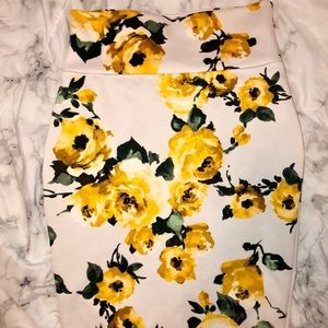 White skirt with yellow floral pattern.